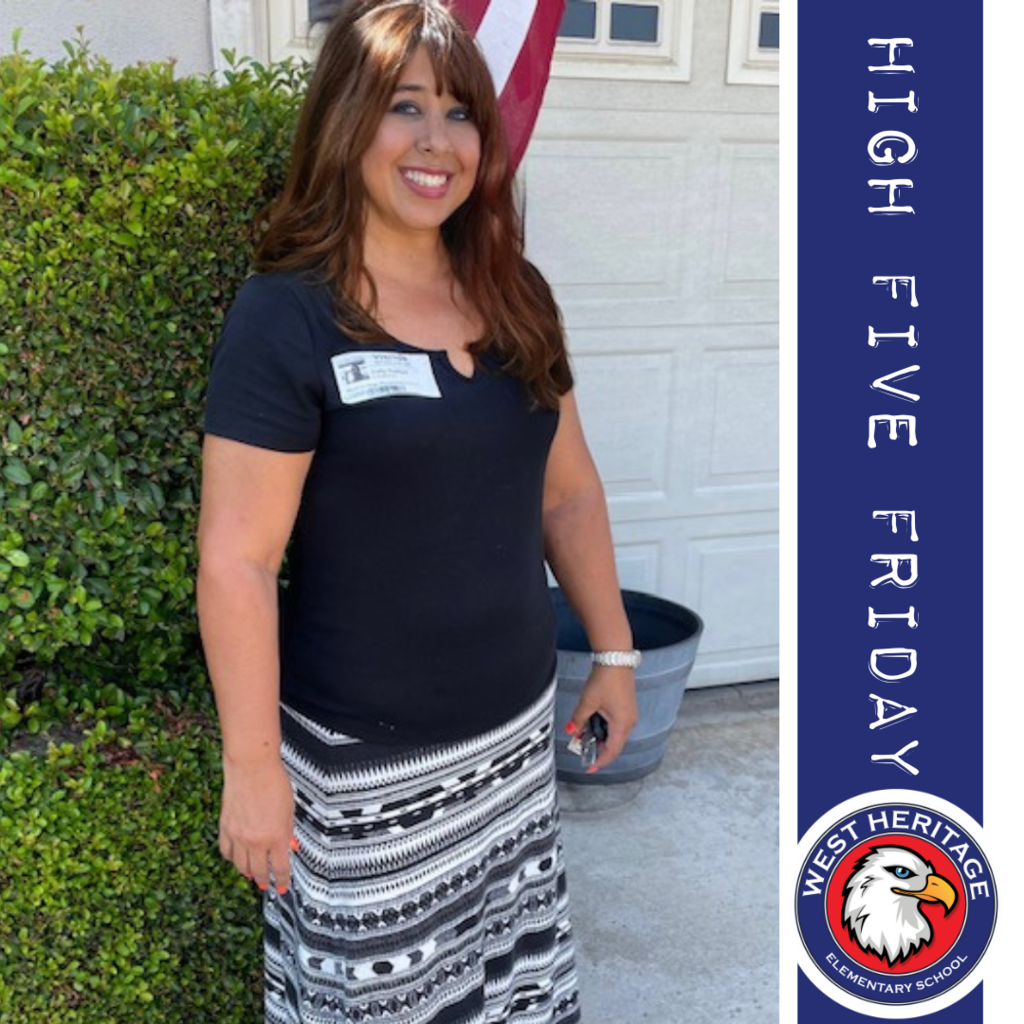 Text: High Five Friday, West Heritage Elementary Image: Woman standing in front of flag
